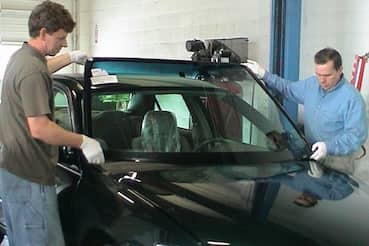 2 men replacing a car windshield